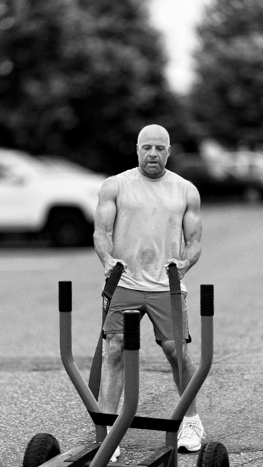 Member pushing a weighted sled